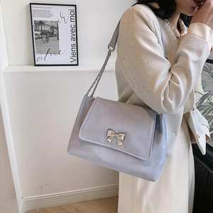 Minimalist light blue butterfly chain shoulder bag with a silver bow flap closure
