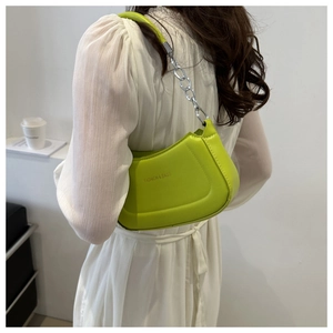 Close-up of lime green hobo bag with silver chain strap and fashion logo text