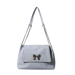 Light grey butterfly crossbody bag with silver chain and bow on white background