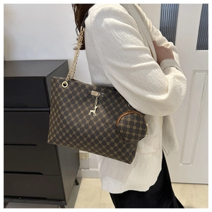 Detail of vintage brown tote bag with chain strap and matching round coin purse