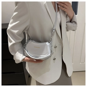 Detail of silver half-moon shoulder bag with metal chain and Fashion & Bags print