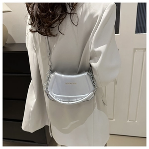 Silver glossy shoulder bag featuring metal chain strap and minimalist text detail
