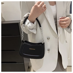 Detail of the black leather shoulder bag with gold 'FASHION & BAGS' text and silver chain