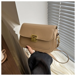 Detail of khaki PU leather crossbody bag featuring a golden rectangular push-lock closure
