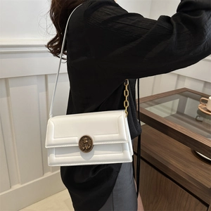 Minimalist white leather crossbody bag with vintage bronze relief buckle and gold chain