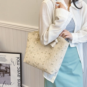 Large straw tote bag for women featuring floral embroidery and hemp rope handles