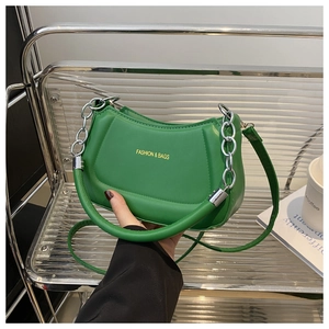 Detail of green crescent bag with silver chain handle and Fashion & Bags printed text
