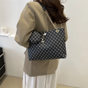 Retro black tote bag with white geometric print, gold chain strap and deer charm