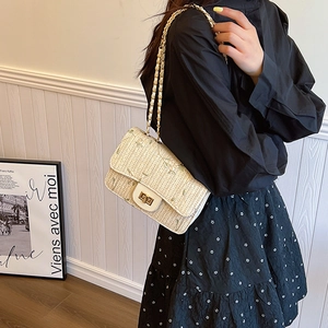 Beige handmade straw shoulder bag with green floral embroidery and gold chain strap