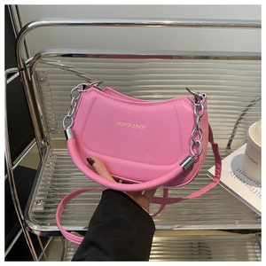 Detailed view of pink PU leather dumpling bag with fashion gold foil lettering and chain strap