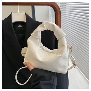 Detail view of white ruched cloud bag with premium PU texture and gold metal hooks