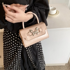 Pink leather crossbody bag for women with silver bow clasp and lychee pattern