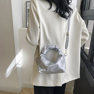 Silver metallic pleated dumpling bag with cloud design and adjustable crossbody strap