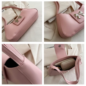 Detail view of pink PU leather shoulder bag showing silver bow decor and interior capacity
