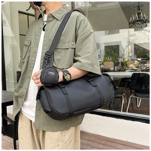 Close-up of black sports duffel bag with detachable mini pouch and adjustable strap