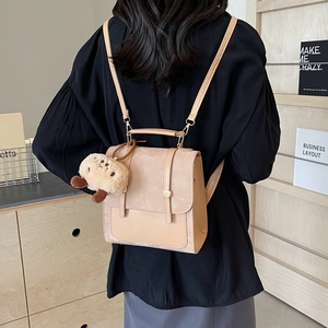 Vintage beige backpack for women featuring soft suede texture and cute teddy bear charm