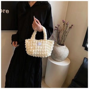 Close-up of cream white bubble texture lunch bag with LOVE FASHION woven label