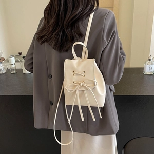 Chic cream bow backpack for women in minimalist Korean style with leather texture