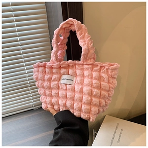 Detail of pink bubble texture tote bag with Love Fashion label and knitted handle
