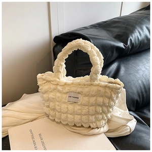 Close-up of cream popcorn fabric lunch bag with LOVE FASHION label and metal zipper