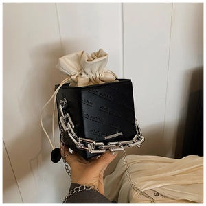 Detail of black box bag featuring rich rabbit embossed leather and chunky silver chain