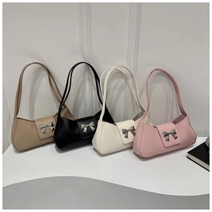 Row of four vintage style underarm bags in khaki, black, white, and pink with silver bows