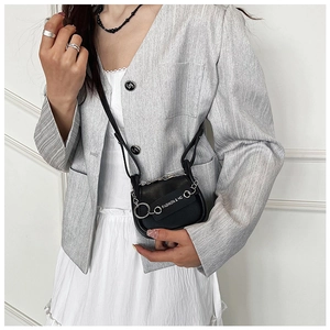 Detailansicht der schwarzen Mini-Satteltasche mit Silberkette und Fashion HC-Schrift