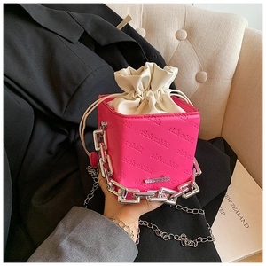 Detail of pink rich rabbit bucket bag with silver chain and textured letter embossing