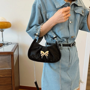 Chic black crescent shoulder bag with silver butterfly buckle and pearl chain handle