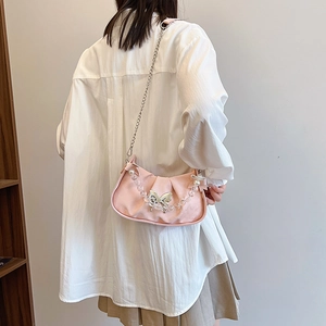 Pink crescent underarm bag with pearl bead handle and silver butterfly charm for women