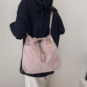 Japanese style dusty pink drawstring crossbody bucket bag with large front pockets