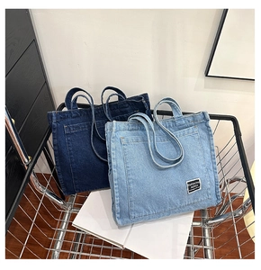 Detailed close-up of dark and light denim tote bags with stylish pocket designs in a basket