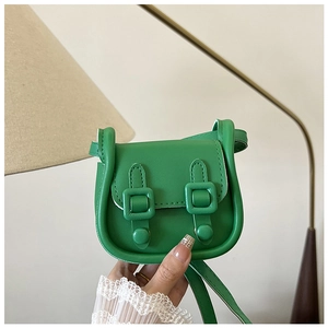 Gros plan du mini sac bandoulière vert affichant la texture du cuir et les boucles dorées