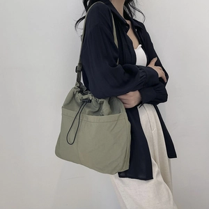Japanese style sage green drawstring bucket bag with adjustable strap for casual daily use