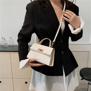 Fashionable off-white rectangular crossbody bag with golden twist lock and top handle