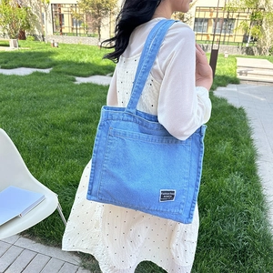 Light blue denim tote bag for women featuring a minimalist design and soft cotton texture