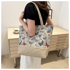 Detail shot of vintage canvas tote bag with colorful butterfly prints on the fabric