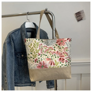 Detail of floral printed canvas tote bag with sturdy shoulder straps for daily leisure