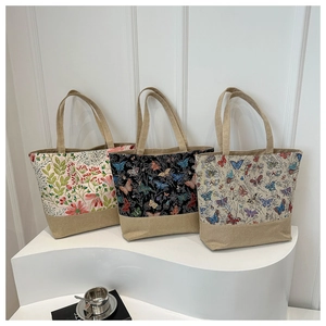 Detailed view of three canvas tote bags with natural floral and butterfly prints