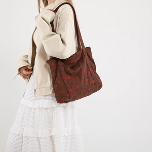 Brown corduroy tote bag with strawberry pattern and wide shoulder straps for daily use