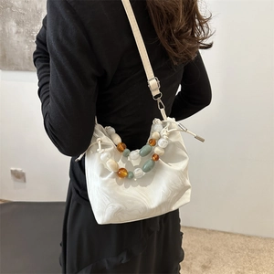 White marble pattern tote bag with decorative bead handle and drawstring closure