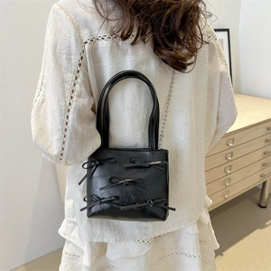 Chic black chain shoulder bag with cute bows, perfect for casual summer fashion