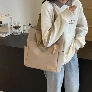 Large khaki canvas tote bag for men and women with fashion label and shoulder strap