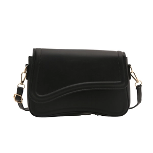 Minimalist black square shoulder bag with wavy asymmetrical flap and gold hardware