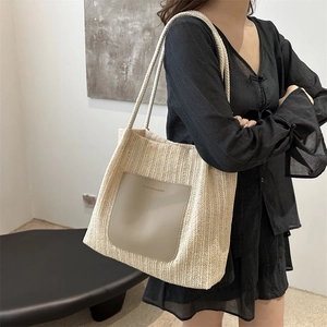 Beige woven tote bag with faux leather pocket and long rope handles for summer