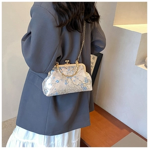 Detailed embroidery on vintage cream brocade shoulder bag with floral patterns