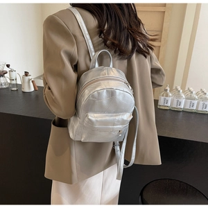 Silver metallic mini backpack featuring geometric stitching on a textured faux leather finish