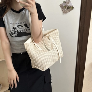 Large capacity beige straw woven tote bag with long handles for summer beach use