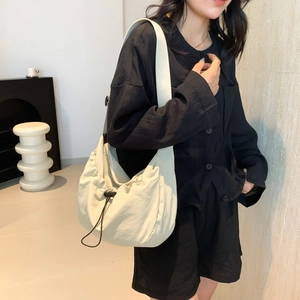 Fashionable cream nylon dumpling crossbody bag with drawstring design and wide strap