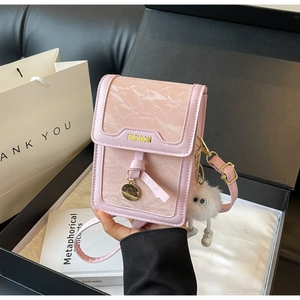Pink mini crossbody bag featuring marble flap texture and cute fur monster pendant